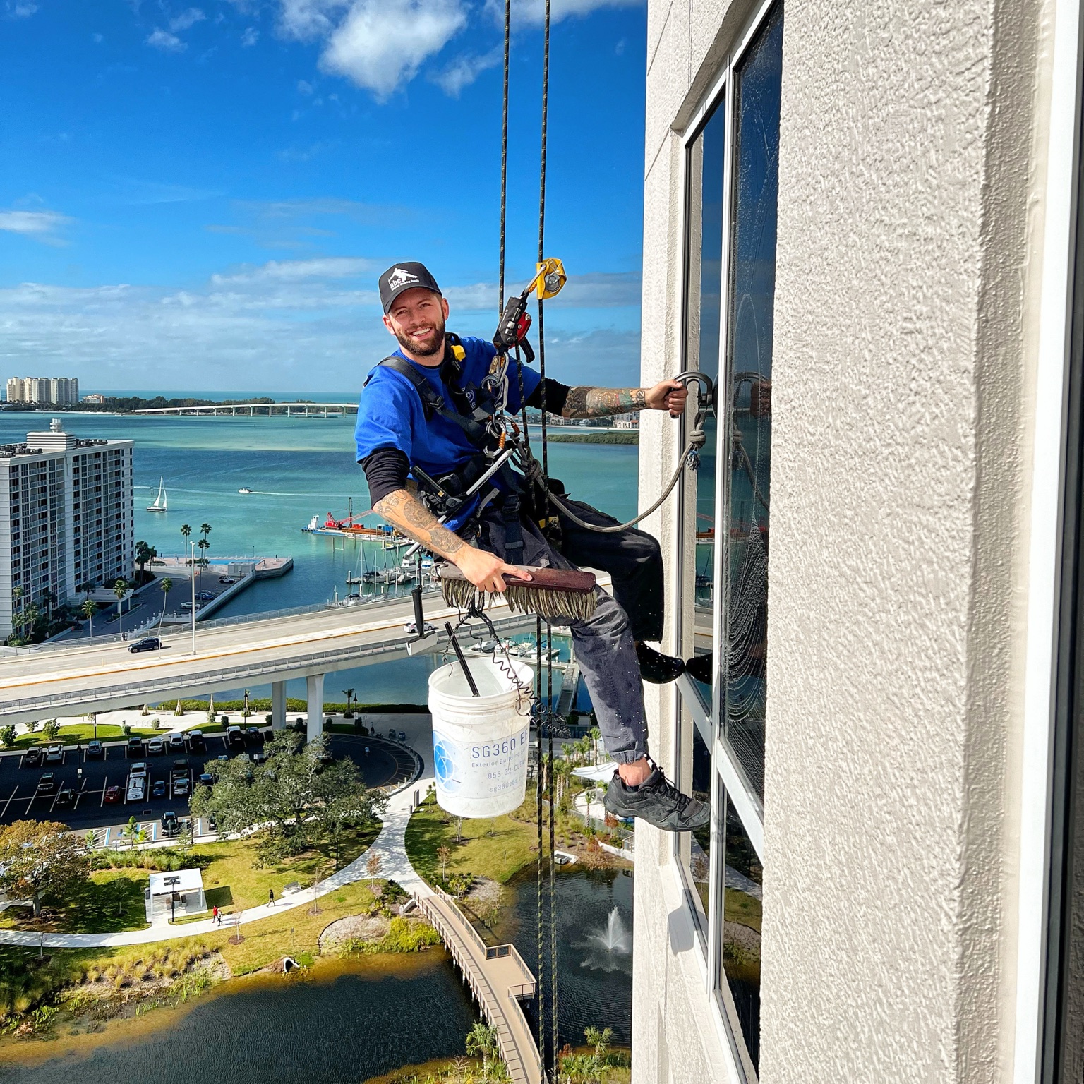 Clear Visions rope-access window cleaner overlooking Tampa Bay